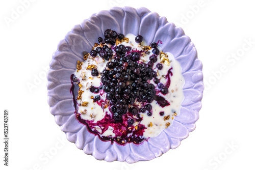 Purple bowl with yogurt, granola, and fresh blueberries. Isolated object