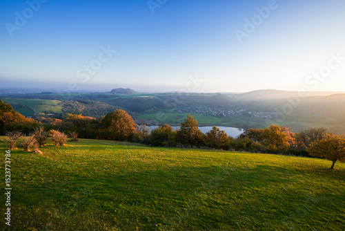 Fototapeta Naklejka Na Ścianę i Meble -  View of the landscape at the Meerfelder Maar. Nature at the crater lake in the Volcanic Eifel National Park. The surrounding area near Meerfeld at sunset in the evening.
