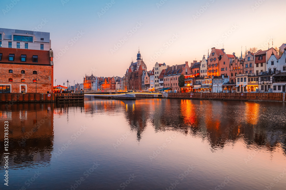 Obraz premium Gdansk with Motlawa river in Poland. Old town colourful house with Zuraw or crane and with Holy Spirit Gate