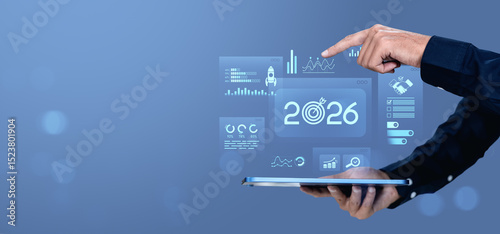 Business hand interacting with futuristic 2026 digital interface on tablet screen.