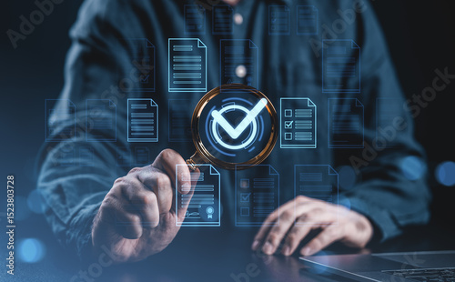 Businessman analyzing digital documents with magnifier and checkmark symbol.