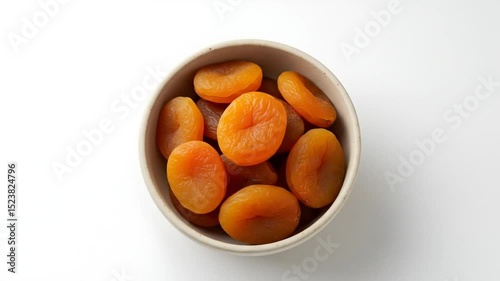 Dried Apricots In Beige Bowl On White Background