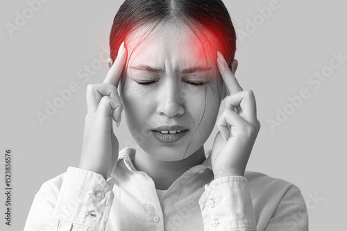 Young Asian woman suffering from headache on beige background. Brain Injury A...