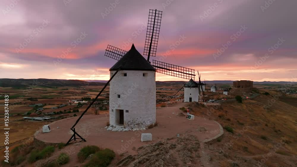Aerial view of the windmills of Consuegra at sunset, Castilla-La Mancha, Spain.