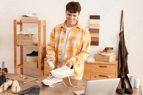 Male shoemaker polishing sn...