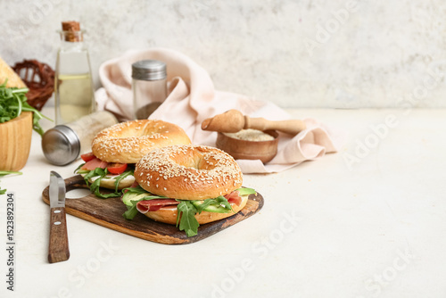 Wooden board of tasty bagel...
