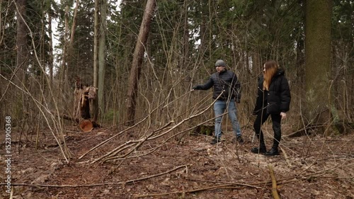 hike with a man using a walking stick and a woman carrying a dog leash, implying a mindful escape into nature with elements of accessibility and leisure