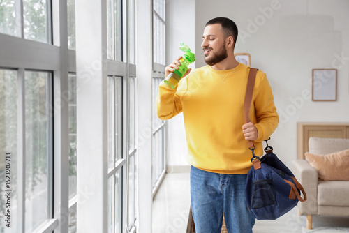 Young man with water bottle...