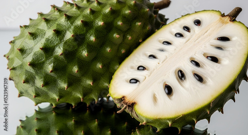 Whole green cherimoya fruit showcases distinctive scale-like pattern on skin. Tropical custard apple ready for consumption. Concept: Specialty produce, gourmet food, exotic fruit shop