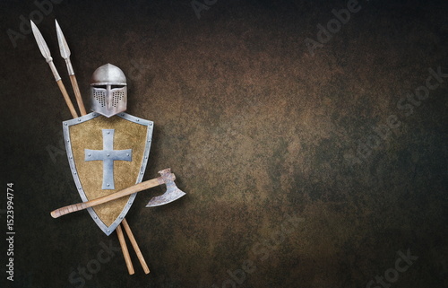 knight's helmet axe shield and two spears on grunge background