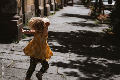 Carefree Child Running on Sunny Street