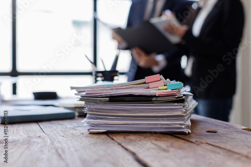 Business Documents,  business people checking and charts to analyze market data, balance sheet, account, net profit to plan new sales strategies to increase production capacity.	
