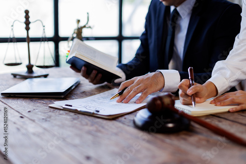 Quadro su tela Two lawyers Consultation and conference discussing legal matters at a desk with a gavel, scales of justice law symbolizing law and justice, justice and lawyer Business partnership meeting concept