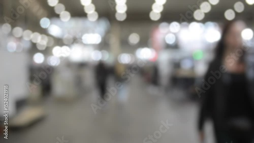 Wallpaper Mural People walking in building. Building with walls, floor, ceiling illuminated lamps. Silhouettes of people indoors. Many people walking. Men and women in tall hall. Exhibition center. Blurred background Torontodigital.ca