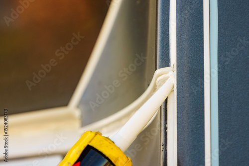 Applying silicon on caravan body