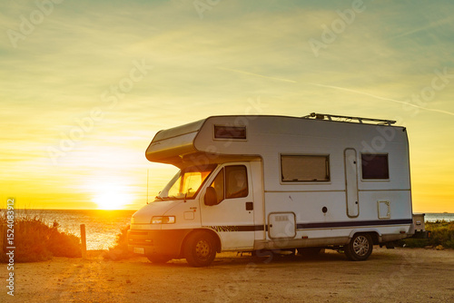 Camper car on beach at sunrise