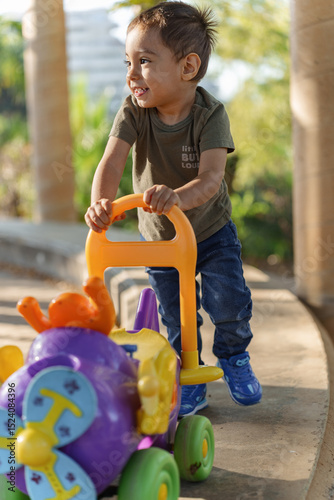little boy playing with toy car