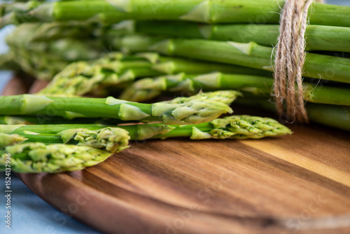 Green Asparagus on a wooden plate