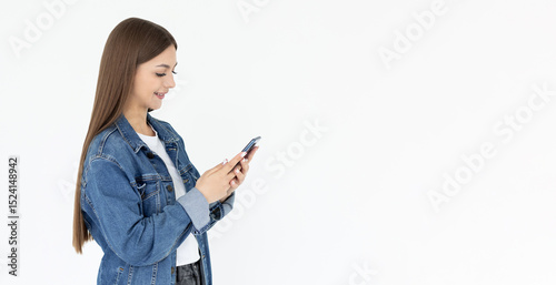 Happy pretty young woman model holding smartphone looking at cell texting message, smiling girl using mobile apps on cell phone standing isolated on white background with cellphone.