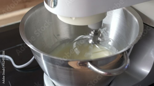 The dough is kneaded using a food processor in the kitchen, while the planetary mixer is also in use.