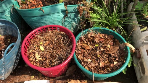 Pile of dry leaves, dry grass and waste food, heap in green plastic basket, fermentation of leaves for produce organic fertilizer, to reduce the burning, to protect the environment.