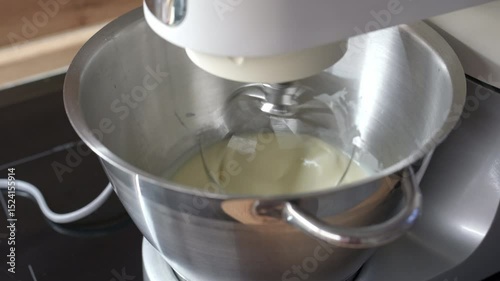 The dough is kneaded using a food processor in the kitchen, while the planetary mixer is also in use.