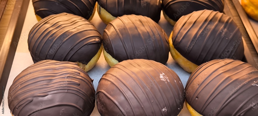 Fototapeta premium Chocolate donuts on a tray in a restaurant