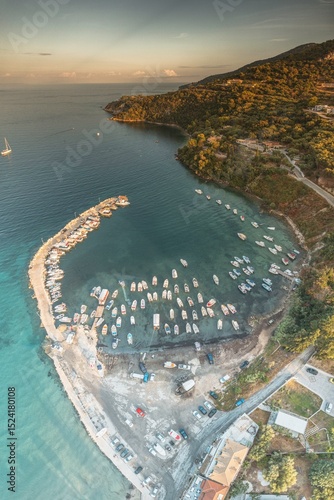 A barefoot wanderer strolls along a sunburnt stone path, past olive trees and fig shadows, holding a vintage postcard, immersed in the tranquil beauty of Zakynthos’ dreamy coastline