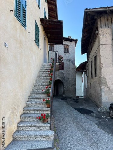 narrow street in the old town with flowers on stairs Italy. 