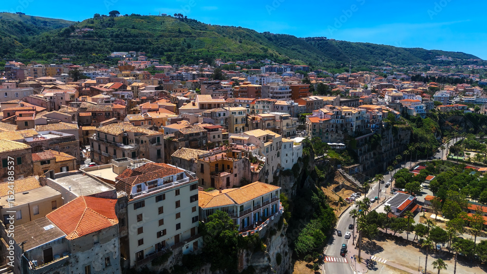 Fototapeta premium Aerial view of Tropea cityscape with colorful buildings overlooking the Tyrrhenian Sea in Calabria, Southern Italy