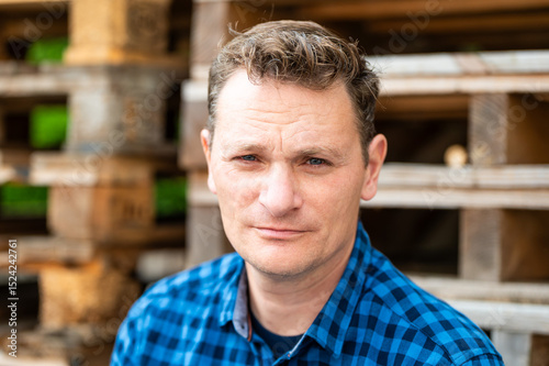 Outdoor portrait of a 46 yo white man wearing a checkered blue shirt, Koekelberg, Belgium