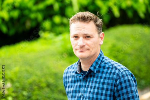 Outdoor portrait of a 46 yo white man wearing a checkered blue shirt, Koekelberg, Belgium