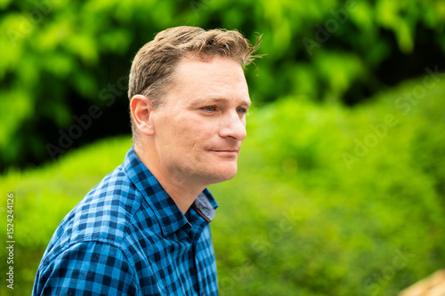 Outdoor portrait of a 46 yo white man wearing a checkered blue shirt, Koekelberg, Belgium