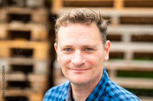 Outdoor portrait of a 46 yo white man wearing a checkered blue shirt, Koekelberg, Belgium
