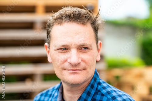 Outdoor portrait of a 46 yo white man wearing a checkered blue shirt, Koekelberg, Belgium