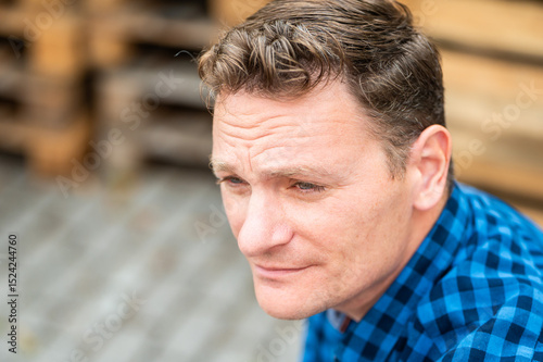 Outdoor portrait of a 46 yo white man wearing a checkered blue shirt, Koekelberg, Belgium