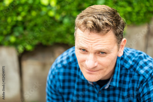 Outdoor portrait of a 46 yo white man wearing a checkered blue shirt, Koekelberg, Belgium