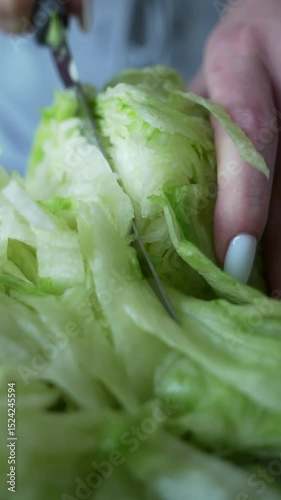 Close-up of slicing juicy iceberg lettuce. No people - 4K
