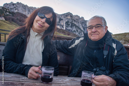 Senior Couple Enjoying Mulled Wine in the Mountains