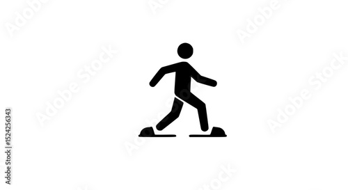 A man is walking on a rocky surface