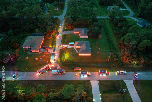 First responders arrived at fire alarm call ready to extinguish fire of burning house. Emergency service personnel responding to potential fire hazard at Florida home
