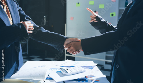 Foto Happy two Asian business man and woman handshake to congratulate success