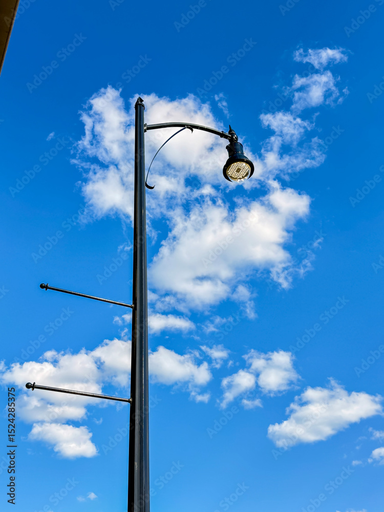 Modern Street Lamp Against Blue Sky with Clouds Modern Street Lamp Against Blue Sky with Clouds
