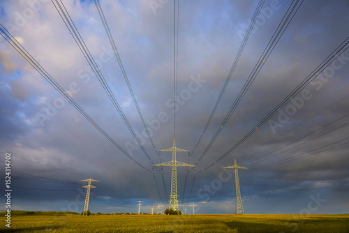 High-voltage power line in high-contrast evening light.