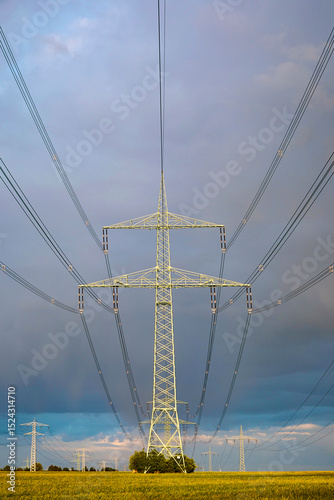 High-voltage power line in high-contrast evening light.