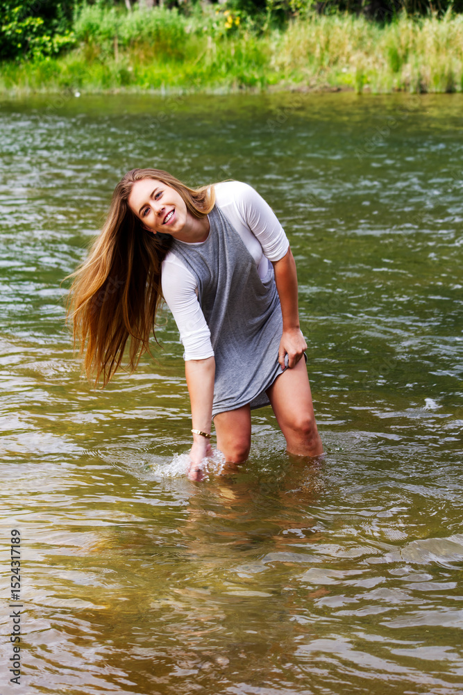 Fototapeta premium Young Caucasian Woman Playing In River Smiling