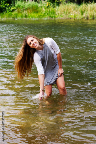 Young Caucasian Woman Playing In River Smiling