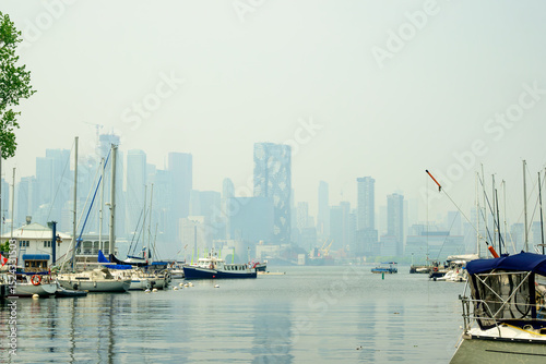 Smoke from distant wild fires over downtown Toronto skyline  at midday on June 6 2025 seen from a yacht club on the Toronto Islands room for text