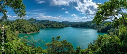 Tropical lake with lush hills.
