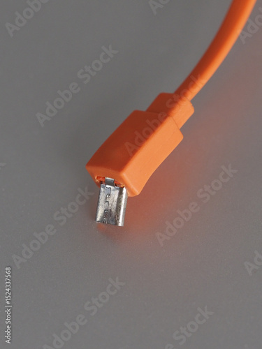 Broken orange USB connector. Close-up.